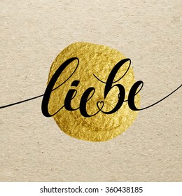 German Valentines day card. Liebe calligraphy lettering with gold paint stain on craft background. Hand drawn letters.