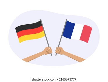 Germany and France flags. French and German national symbols. Hand holding waving flag. Vector illustration.