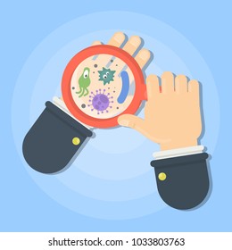 Germs on hand. Watching in magnifying glass.