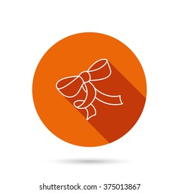 Gift bow icon. Present decoration sign. Ribbon for packaging symbol. Round orange web button with shadow.
