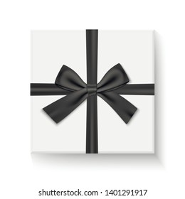 Gift box with black ribbon and bow. Closed white box top view.