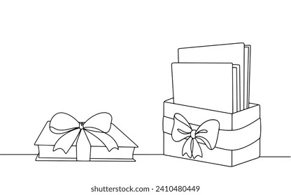 Gift box with a bow containing books. The gift book lies nearby. A gift for a lover of reading. Gift wrap. Images produced without the use of any form of AI software at any stage. 