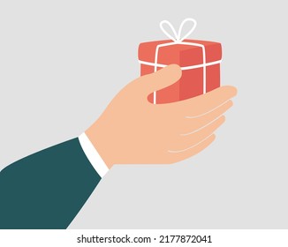 Gift box to celebrate birthday or anniversary. A hand of a woman or a man holding a surprise gift as a sign of love. Concept of Christmas celebration, philanthropy and charity. Vector illustration