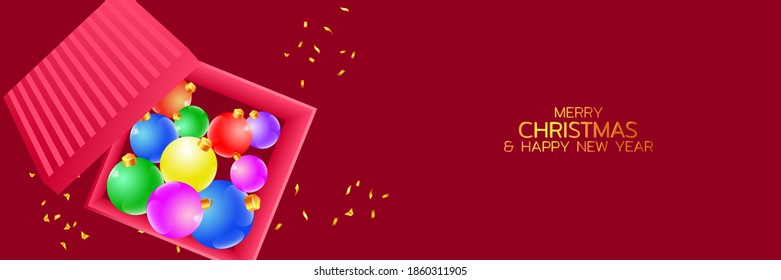 Gift box with Christmas decors. Christmas balls in an open box and golden confetti