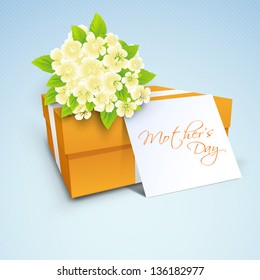 Gift box, flowers and tag with text mothers day, concept for Happy Mothers Day celebration.