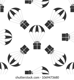Gift box flying on parachute icon seamless pattern on white background. Delivery service, air shipping concept, bonus concept. Flat design. Vector Illustration