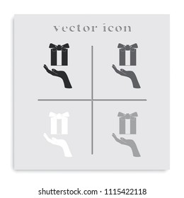 Gift box in hand flat black and white vector icon.