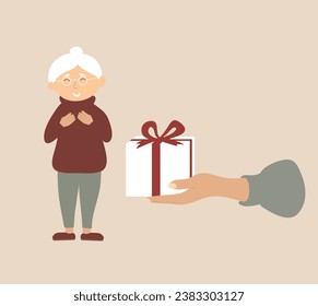 Gift box in hand for grandmother. Christmas surprise for an old smiling woman.