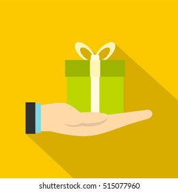Gift box in hand icon. Flat illustration of gift box in hand vector icon for web design