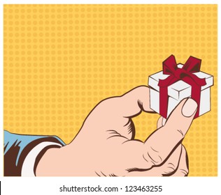 Gift box in hand with red bow and ribbons