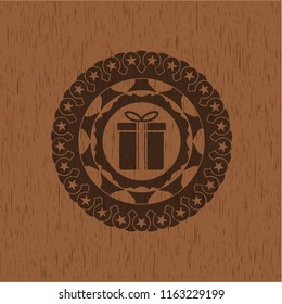 gift box icon inside badge with wooden background