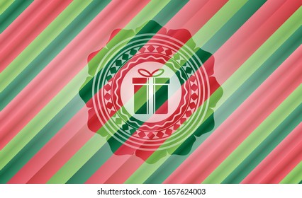 icono de la caja de regalo dentro del emblema de los colores de Navidad.