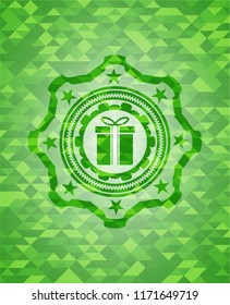gift box icon inside green emblem with mosaic background
