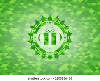 gift box icon inside green emblem with triangle mosaic background