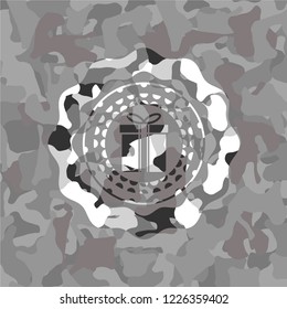 gift box icon inside grey camouflage emblem