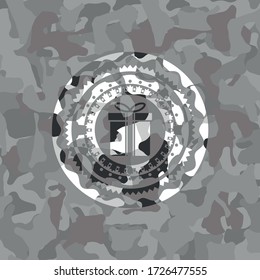 gift box icon inside grey camouflage texture. 