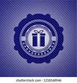 gift box icon inside jean or denim emblem or badge background