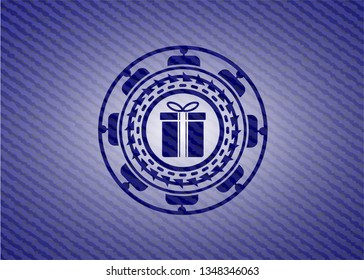 gift box icon inside jean or denim emblem or badge background