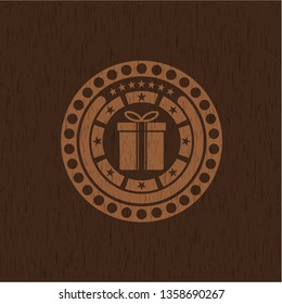 gift box icon inside realistic wood emblem