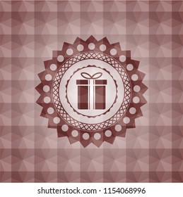 gift box icon inside red seamless badge with geometric background.