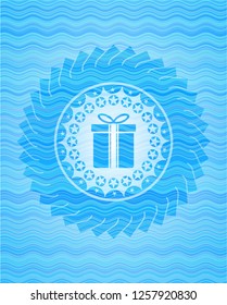 gift box icon inside water representation style emblem.