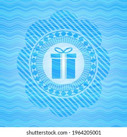 gift box icon inside water wave concept badge background. 