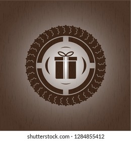 gift box icon inside wood badge or emblem