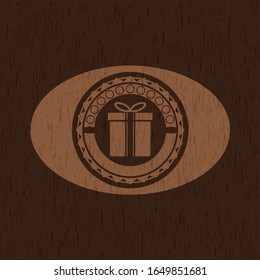 gift box icon inside wood badge or emblem