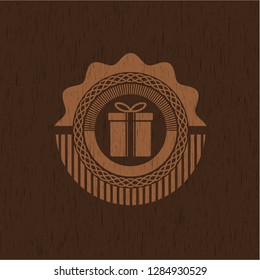 gift box icon inside wooden emblem. Vintage.