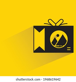 gift box with label shadow on yellow background