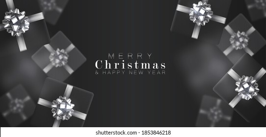 Gift box with motion blur effect. Merry Christmas and Happy New year. Realistic background with voluminous black gifts tied with a silver ribbon with bows. The view from the top.
