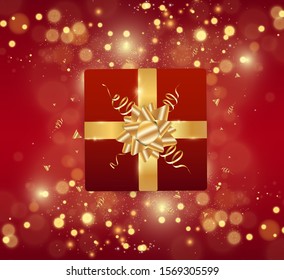 
Gift in a box. New Year or holiday present with a gold bow and sparkle.