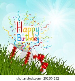 Gift box on green grass