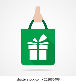 Gift box on green shopping bag icon.  Flat design.Vector EPS 10