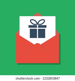 gift box in opened red xmas envelope, secret santa concept