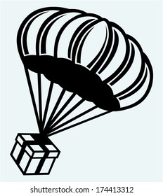 Gift box parachute falling from the sky. Image isolated on blue background