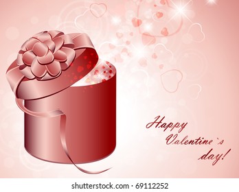 gift box with pink bow over holiday background with hearts