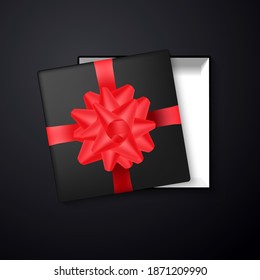 Gift box. Realistic black box with red ribbon and bow top view