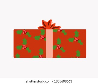 Caja de regalo roja con un arco y hojas y bayas