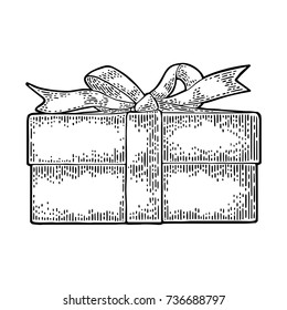 Gift box with ribbon and bow. For Merry Christmas and Happy New Year poster or greeting card. Isolated on white background. Vector vintage black engraving illustration.
