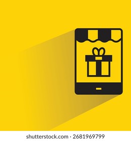gift box in smartphone icon with shadow yellow background
