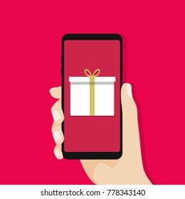 Gift box in smartphone screen. Hand hold smartphone. vector