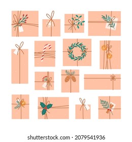 Gift boxes in crafting paper with branch of berries, candy cane, green leaves, cones, mistletoe, cinnamon and orange slice . Eco package with decor elements. Flat vector illustration.