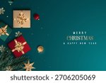Gift boxes in rich colors with festive decorations on teal background create joyful atmosphere. Horizontal Christmas header for website template, flat top view.