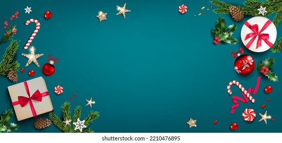 Gift boxes, sweets, holly, stars, fir tree branches and confetti on dark green holiday background. Holiday winter design elements. Christmas background with festive decorations