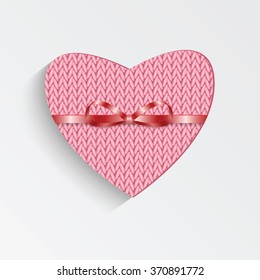 Gift card in the form of heart for Valentine's day.Knitted pink heart with  ribbon