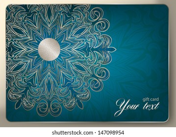 Gift card on a blue patterned background. The idea for a Christmas or wedding card invitation