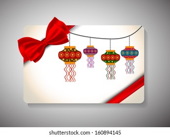 Gift Cards for Happy New Year and Merry Christmas celebrations with red bow and hanging decorative lights.