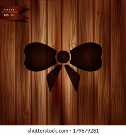 Gift, Christmas bow web icon. Wooden background.