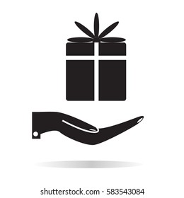 a gift in the hand icon. hand and gift sign.